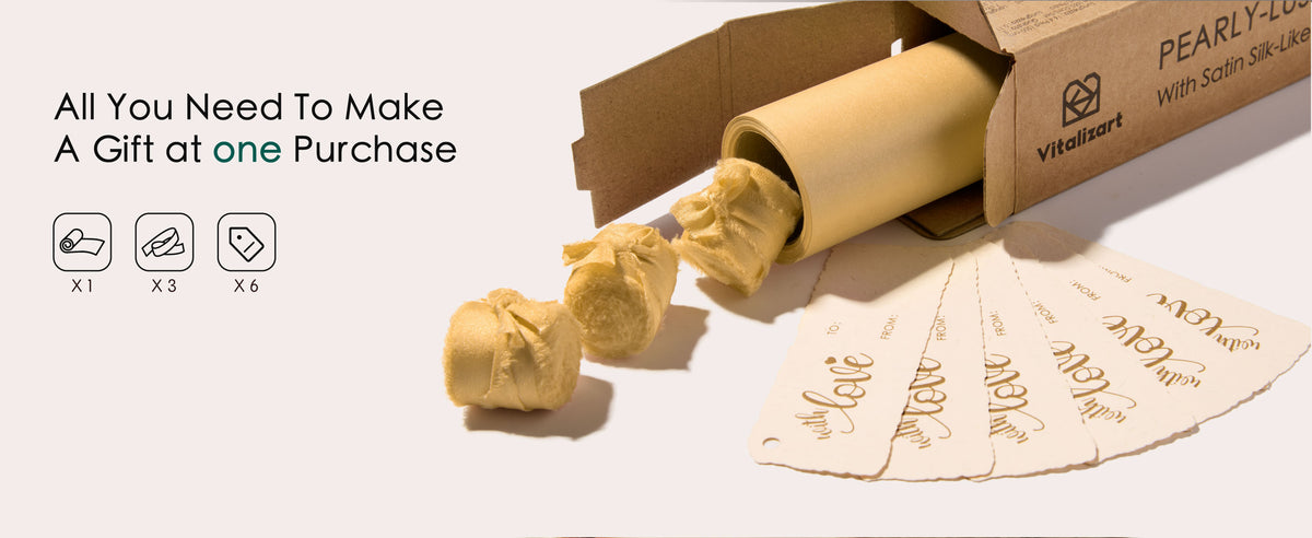 Gold pearly wrapping paper set with rolled paper, matching satin ribbon, and coordinating gift tags