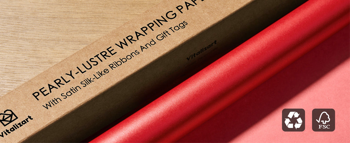 Red pearly wrapping paper beside its kraft box with recycling and FSC symbols