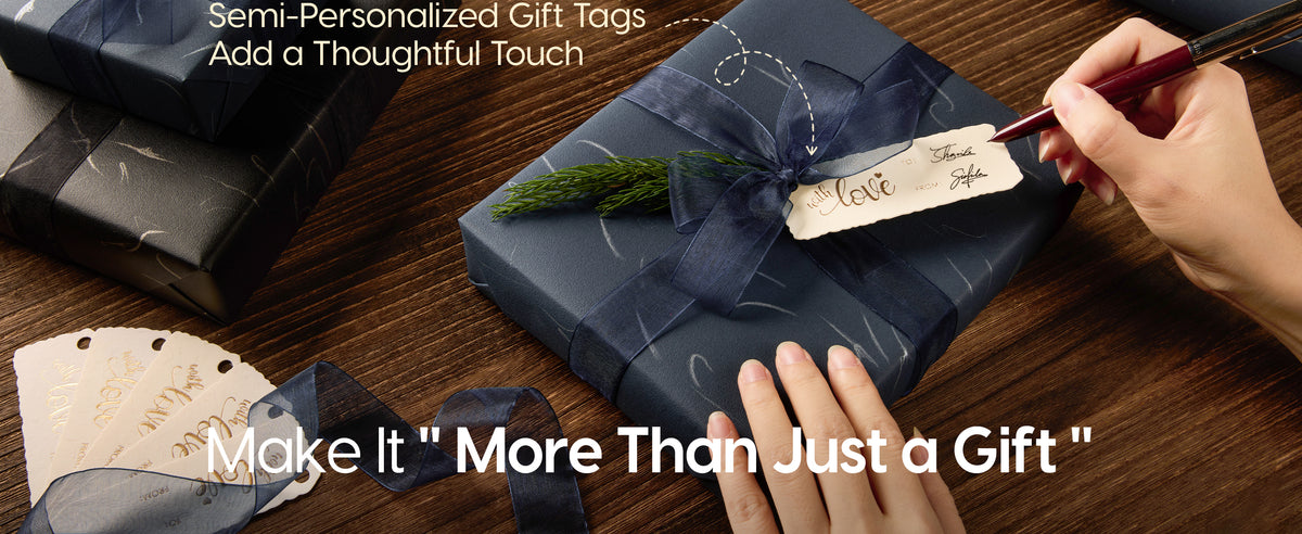 Hand writing a cream gift tag on a navy silver-patterned present tied with organza ribbon.