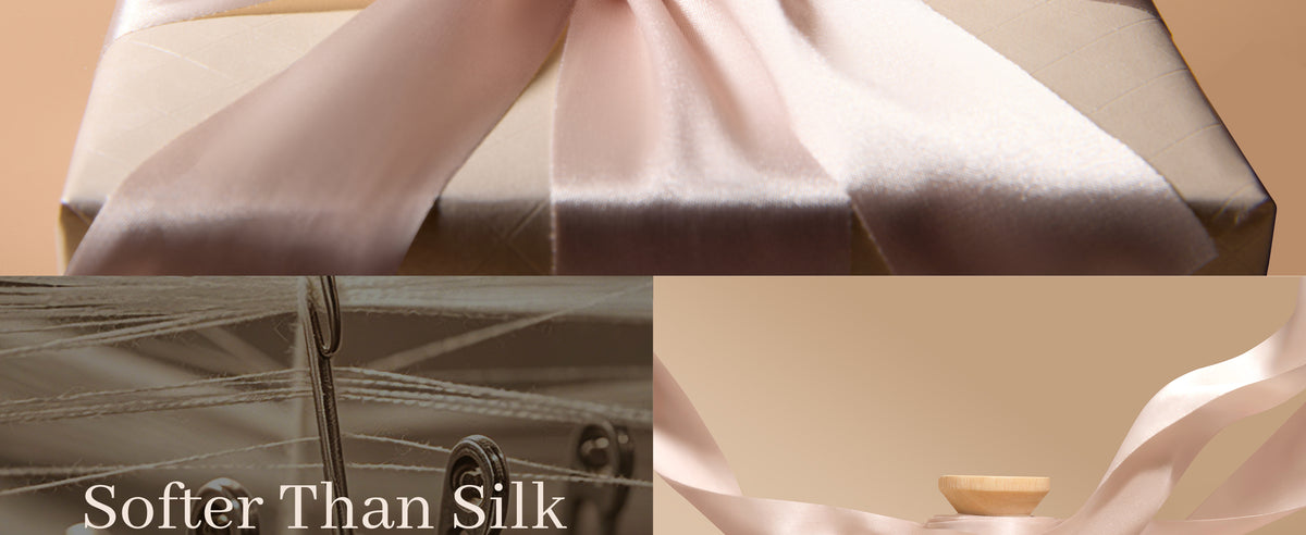 Close-up of blush-nude satin ribbon draped over a box, with textile machinery in the background.
