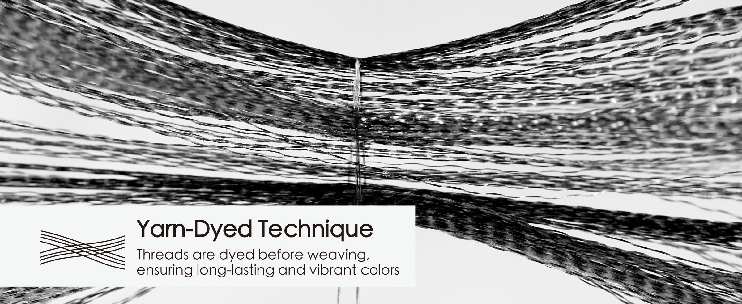 Black ribbon threads spread across a white background to illustrate the yarn-dyed construction.