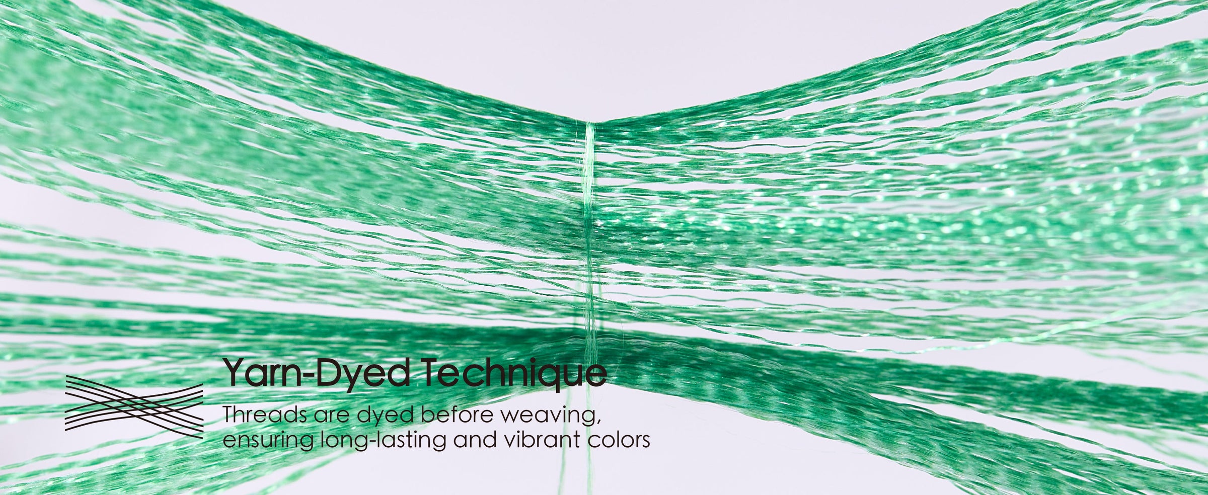 Separated green ribbon threads converge to illustrate the yarn-dyed weaving technique