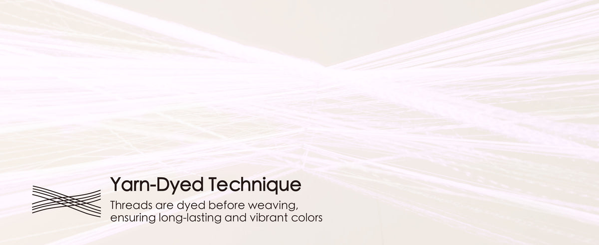 Fine pale pink ribbon threads converge to illustrate the yarn-dyed weaving technique