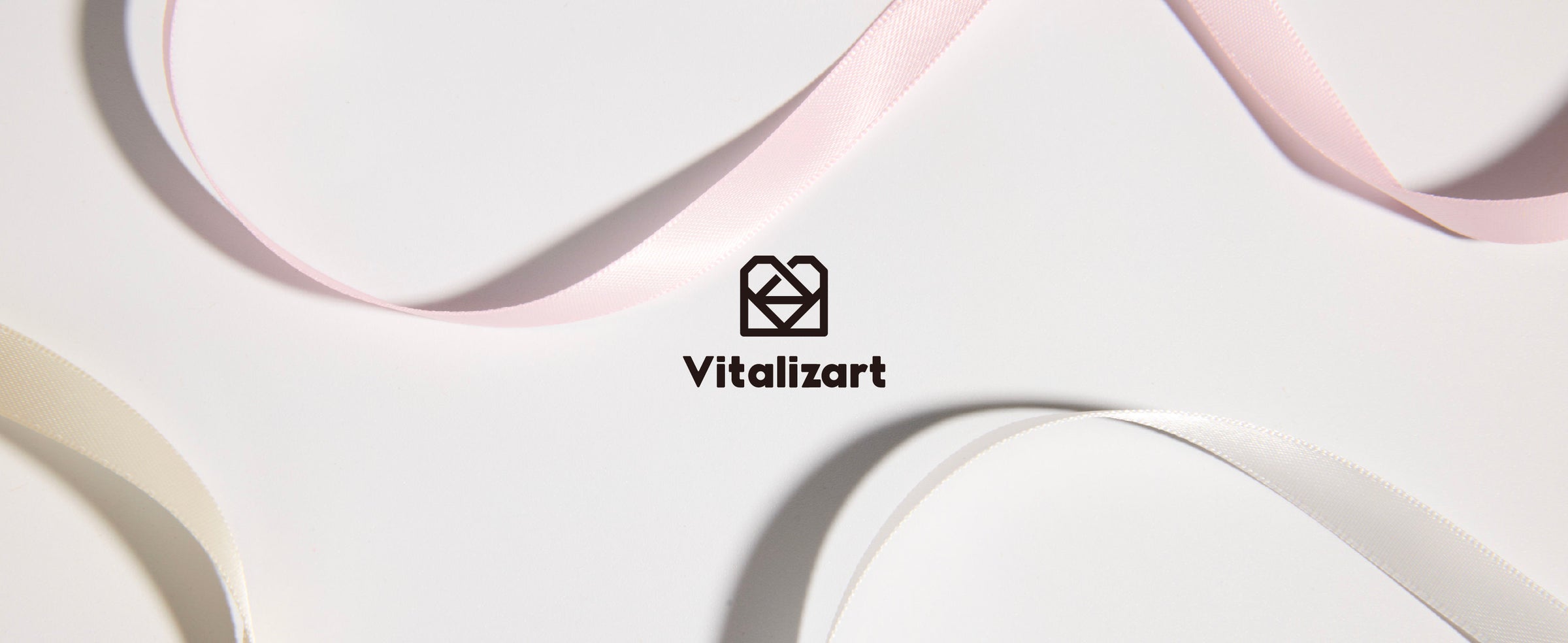 Looped strands from the pink and white double-faced satin ribbon set displayed in coordinated tonal colors