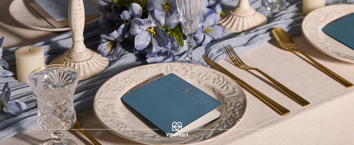 Dusty sage embossed thank-you card styled as a place card in a dining setting