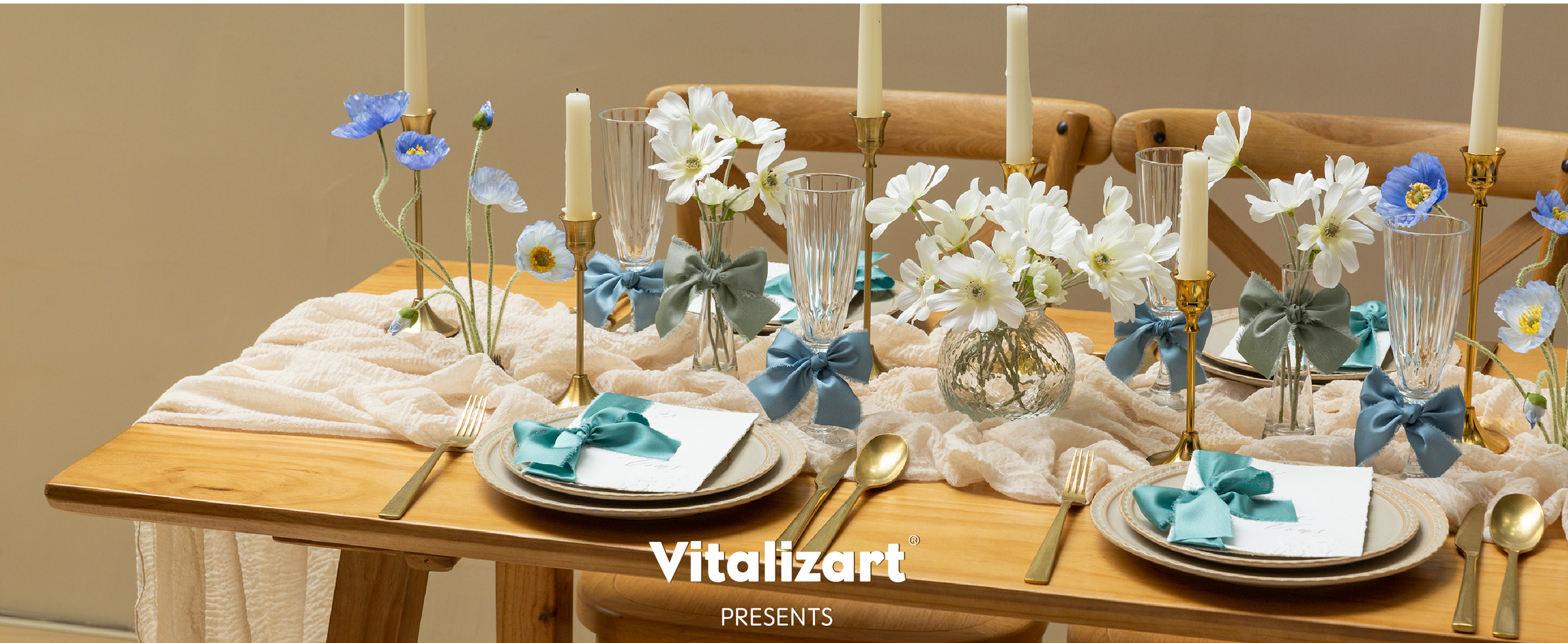 Blue, turquoise, and sage satin bows accent a cream table with flowers and candles