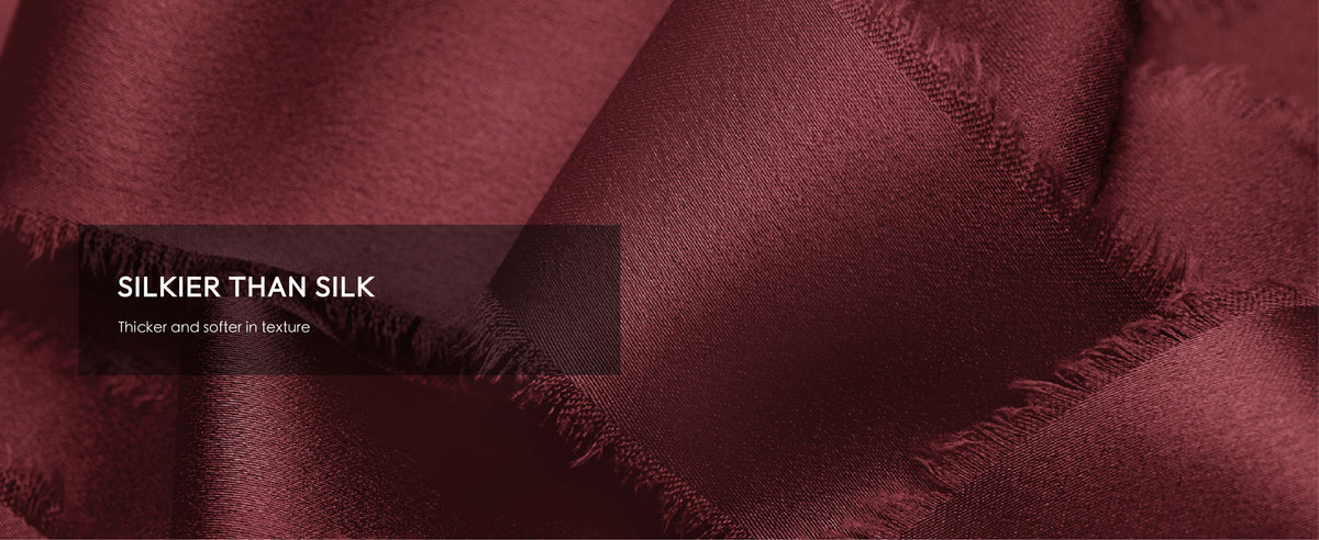 Close-up of burgundy satin ribbon showing a lustrous woven texture and soft frayed edges
