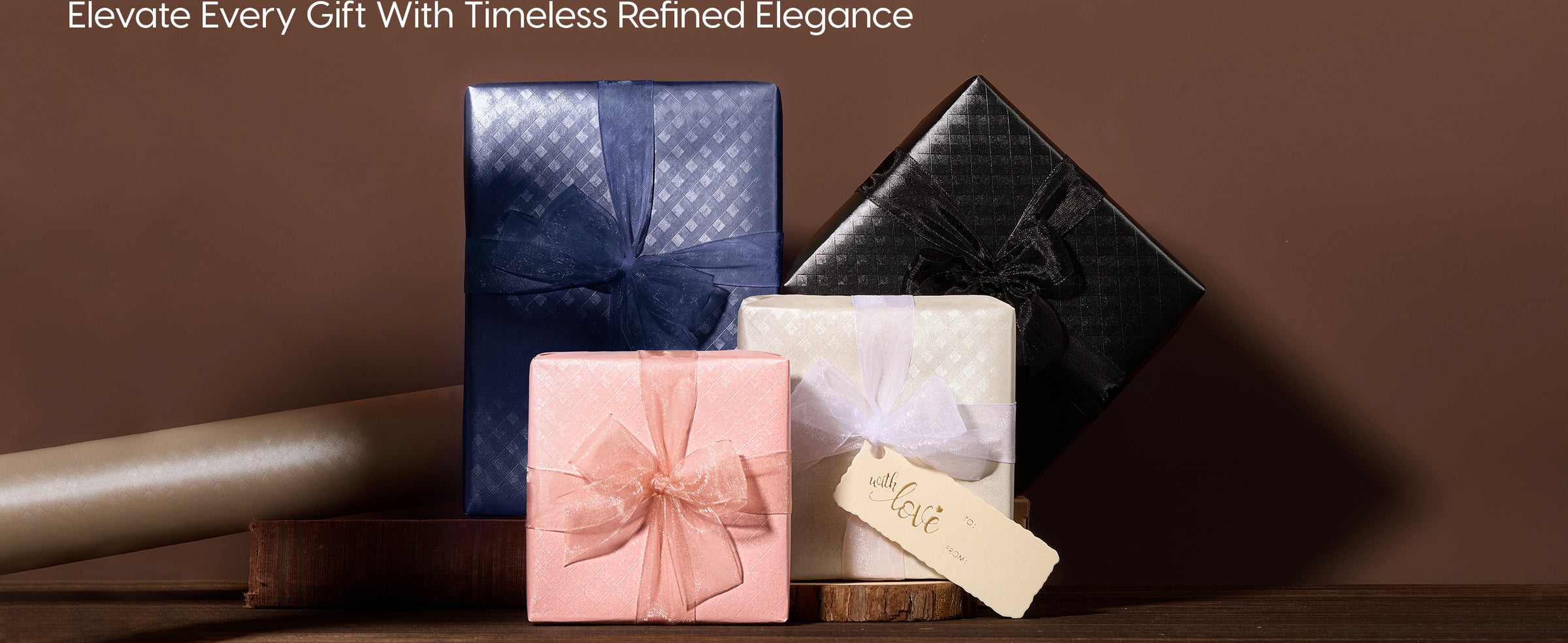 Four gifts in pearlescent grid wrapping paper with sheer bows in navy, black, pink, and ivory.