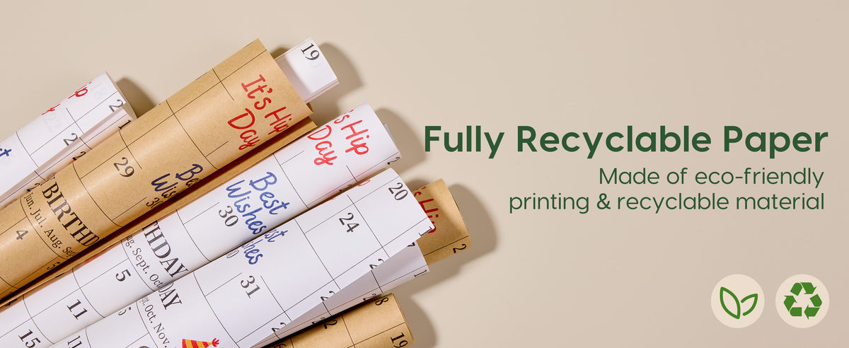 White and kraft calendar-print birthday wrapping paper rolls with leaf and recycling symbols.