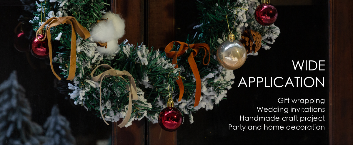 Snowy holiday wreath decorated with terracotta velvet bows, pinecones and colorful ornaments.