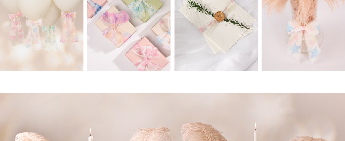 Pastel frayed chiffon ribbon decorating a wax-sealed card and a clear vase filled with blush feathers