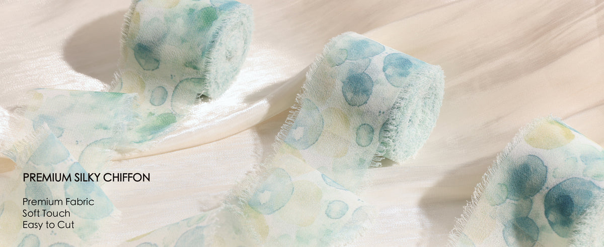 Aqua circle-print silky chiffon ribbon rolls with sheer fabric and soft frayed edges on cream satin