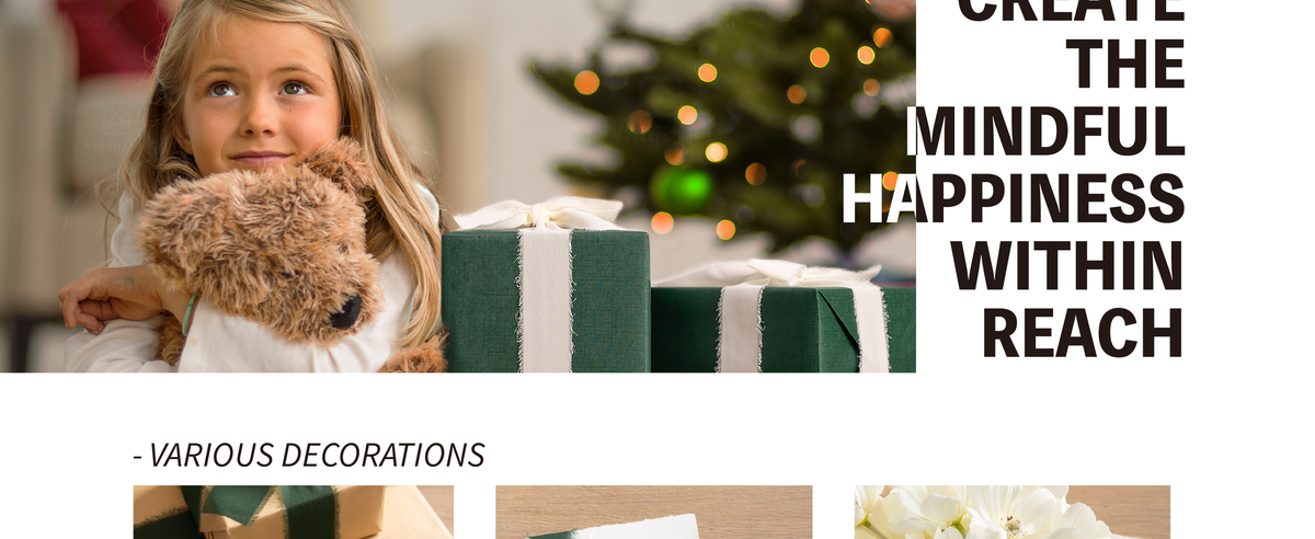 Smiling child hugs a plush dog beside a dark green gift tied with cream fringed chiffon ribbon