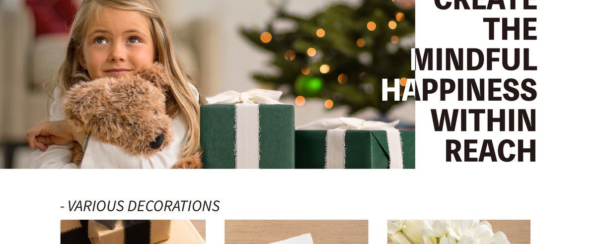 Girl hugging a plush dog beside a green gift box tied with wide white fringed ribbon.