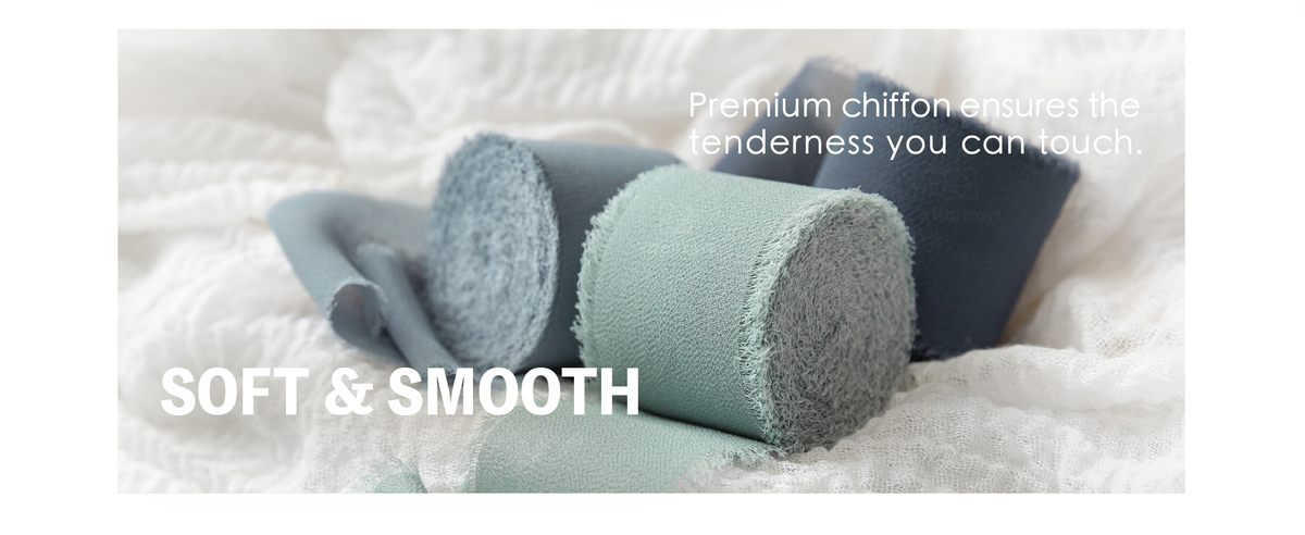 Close-up of dusty blue, pale blue-green, and slate chiffon ribbon rolls with woven texture and fringed edges.