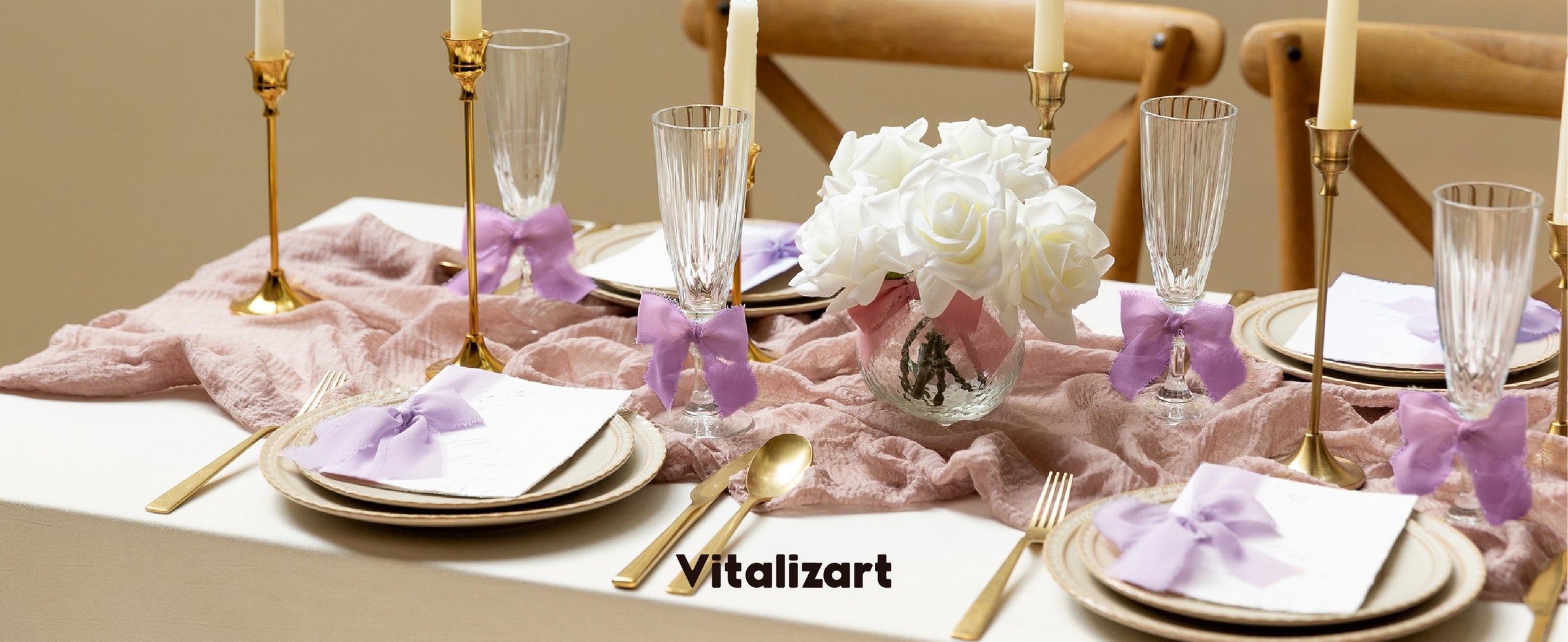 Lavender ribbon bows decorate glasses and place cards on an elegant candlelit dinner table