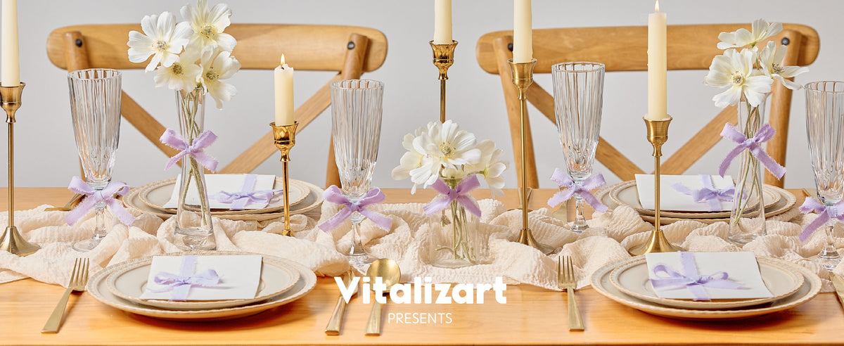Lavender fringed ribbon bows decorate vases, glasses, and cards on a candlelit dining table