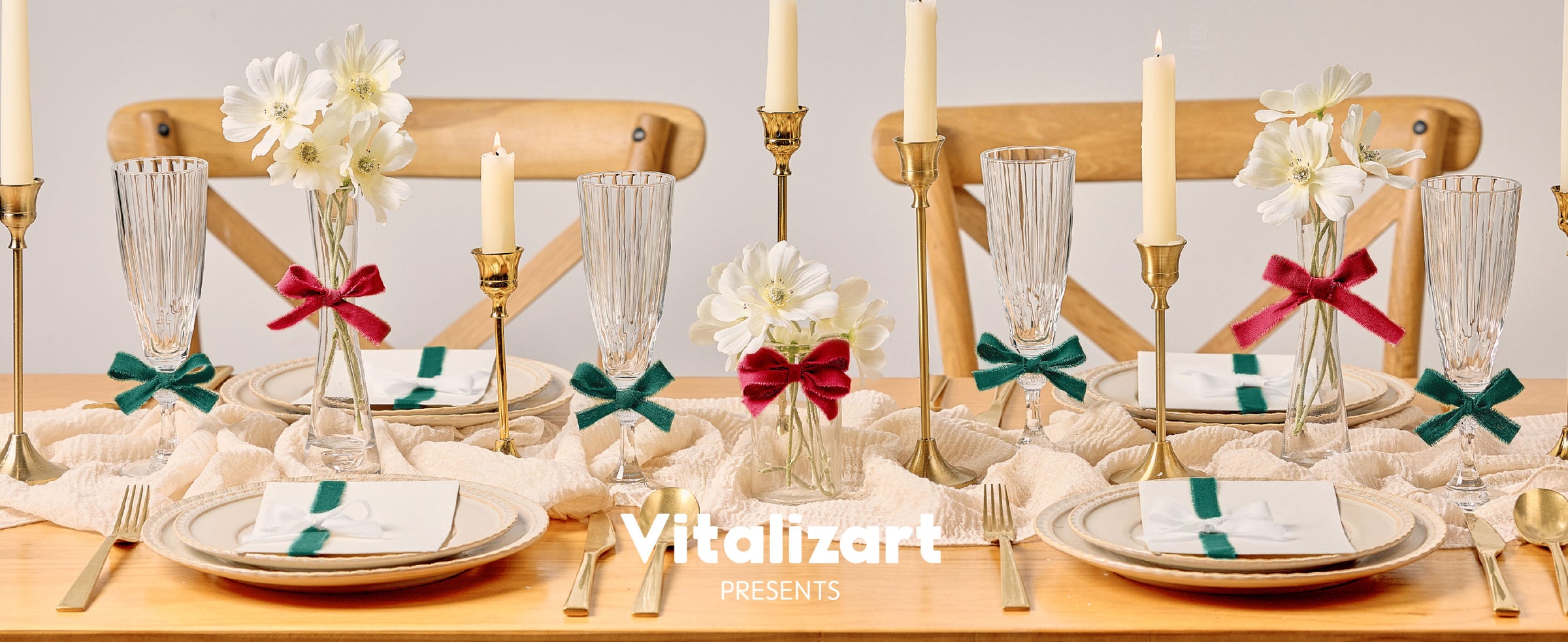 Red and green cotton ribbon bows decorating vases, glasses, and napkins on a candlelit dining table