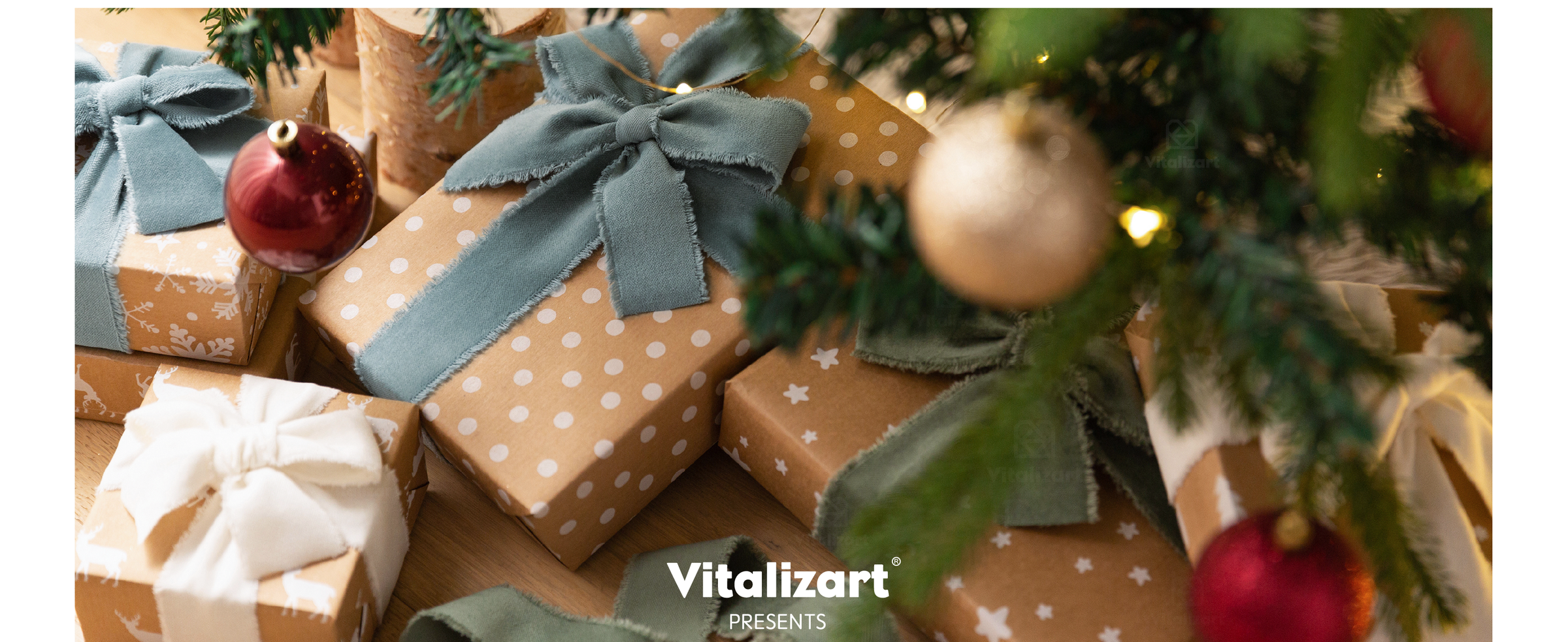 Kraft holiday gifts tied with blue-gray, green, and white frayed ribbons under a Christmas tree
