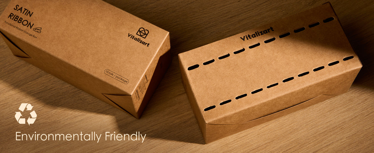 Two brown cardboard ribbon dispenser boxes with slot openings on a wooden surface
