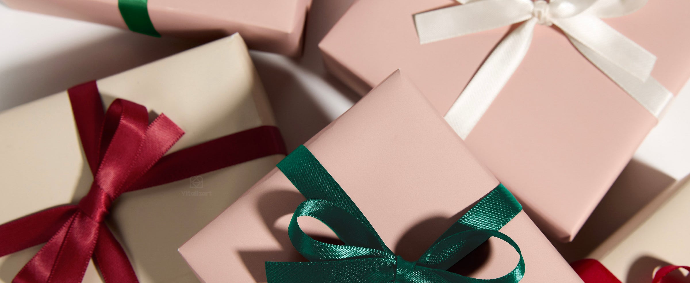 Five-roll polyester satin ribbon set in burgundy, red, cream, green, and teal with dispenser box.
