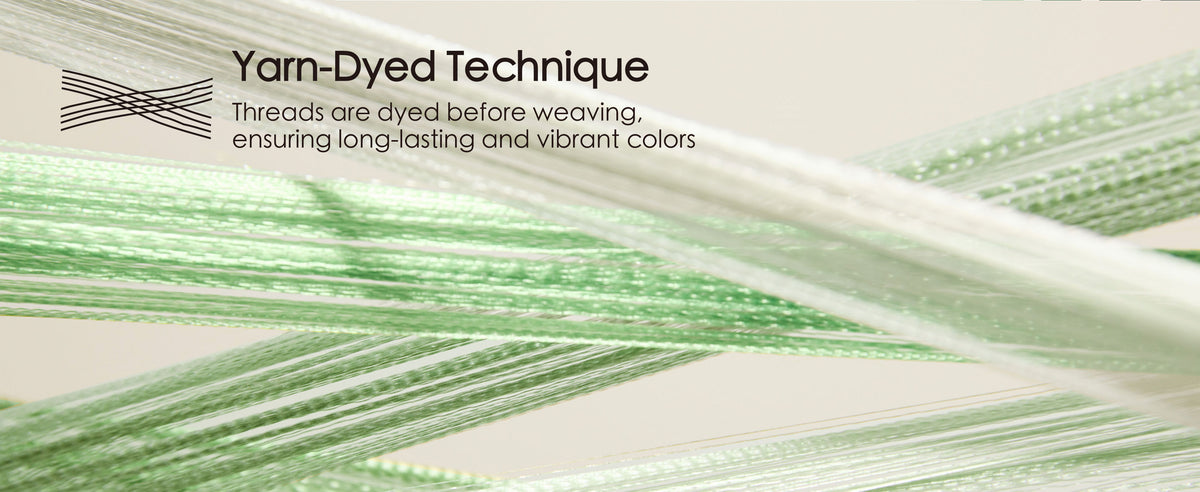 Magnified cream and green ribbon threads crossing to show the yarn-dyed weave