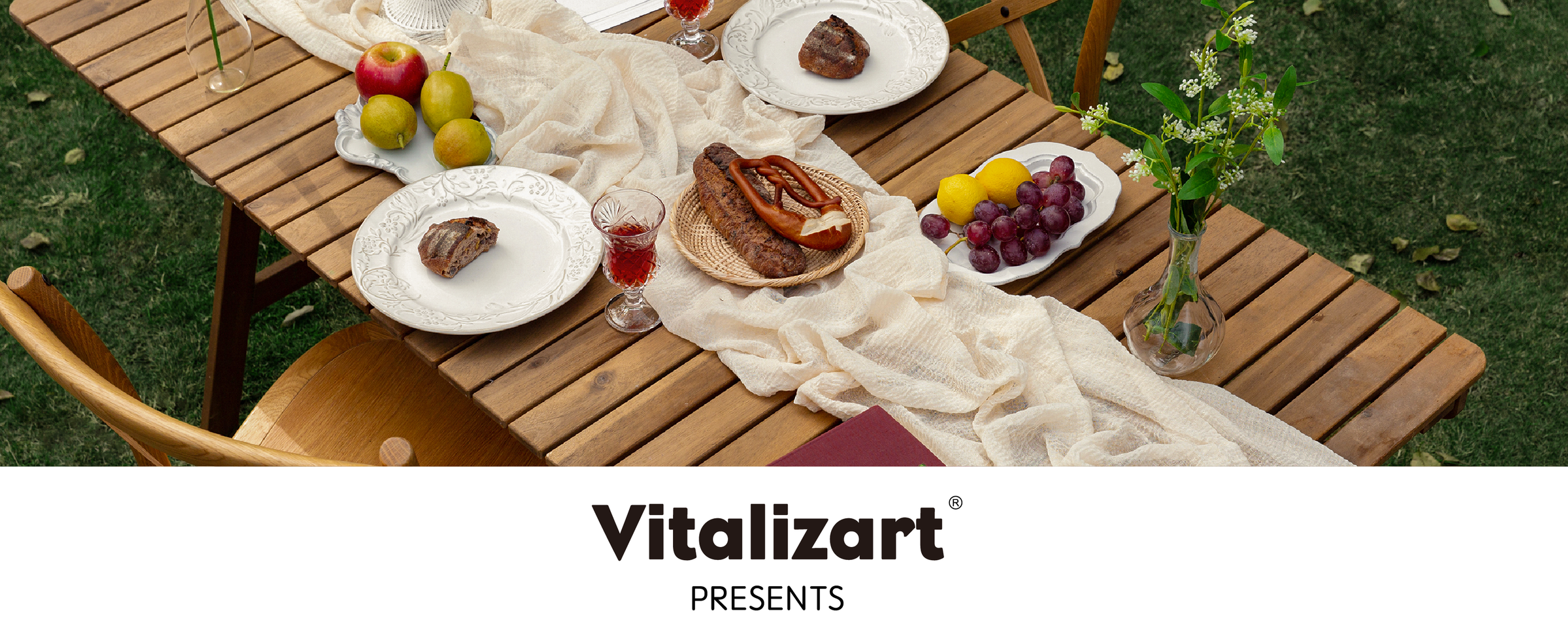 Ivory cheesecloth table runner draped across an outdoor table set with fruit, bread, and drinks.