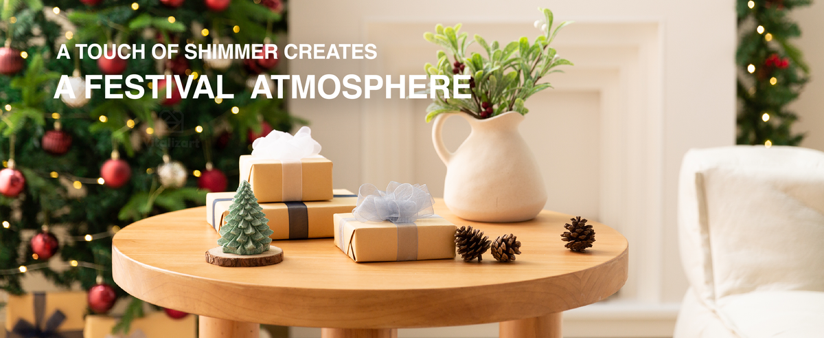 Blue, white, and gray sheer ribbons wrap holiday gifts beside pinecones and a glowing Christmas tree