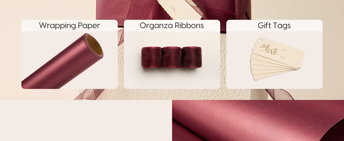 Burgundy pearlescent wrapping paper set with organza ribbons, gift tags, and a wrapped box.