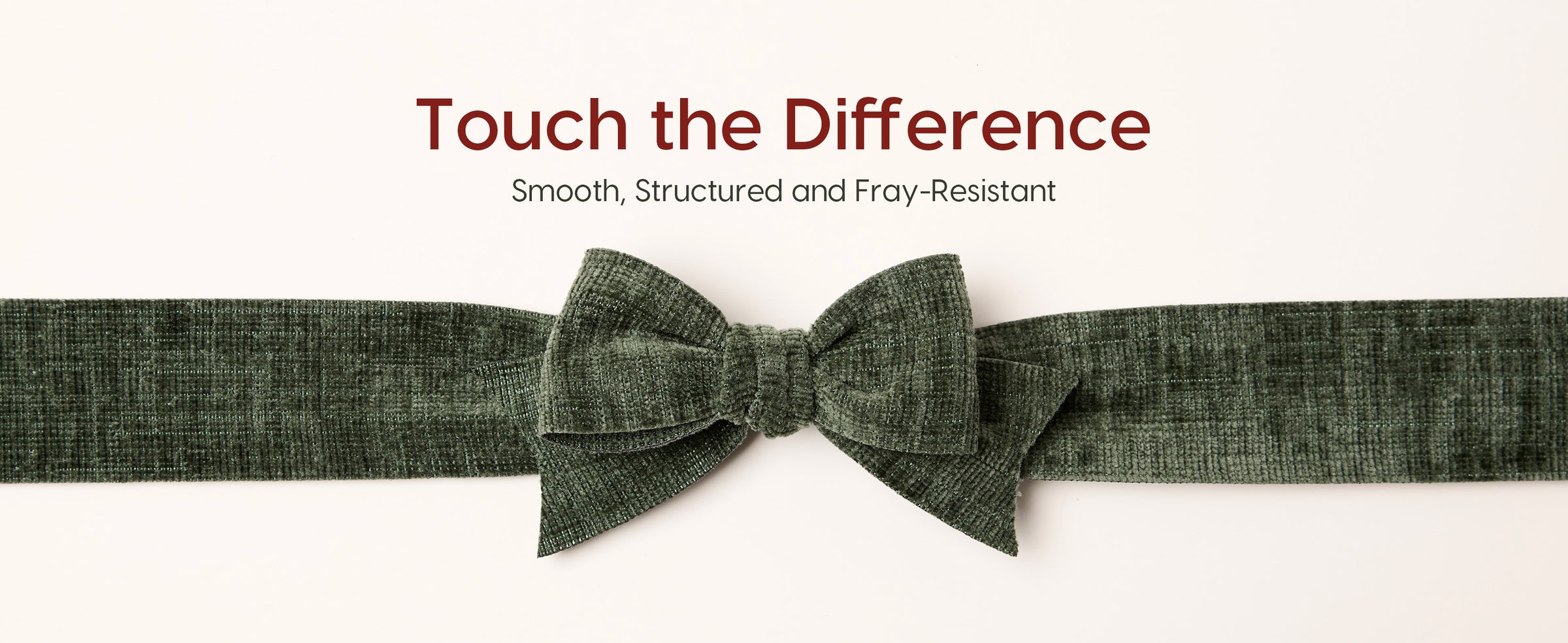 Close-up of an olive-green textured velvet ribbon tied into a structured layered bow