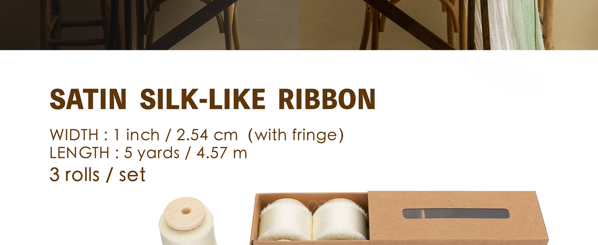 Three cream satin ribbon rolls on wooden spools, each 1 inch wide and 5 yards long, with frayed edges.