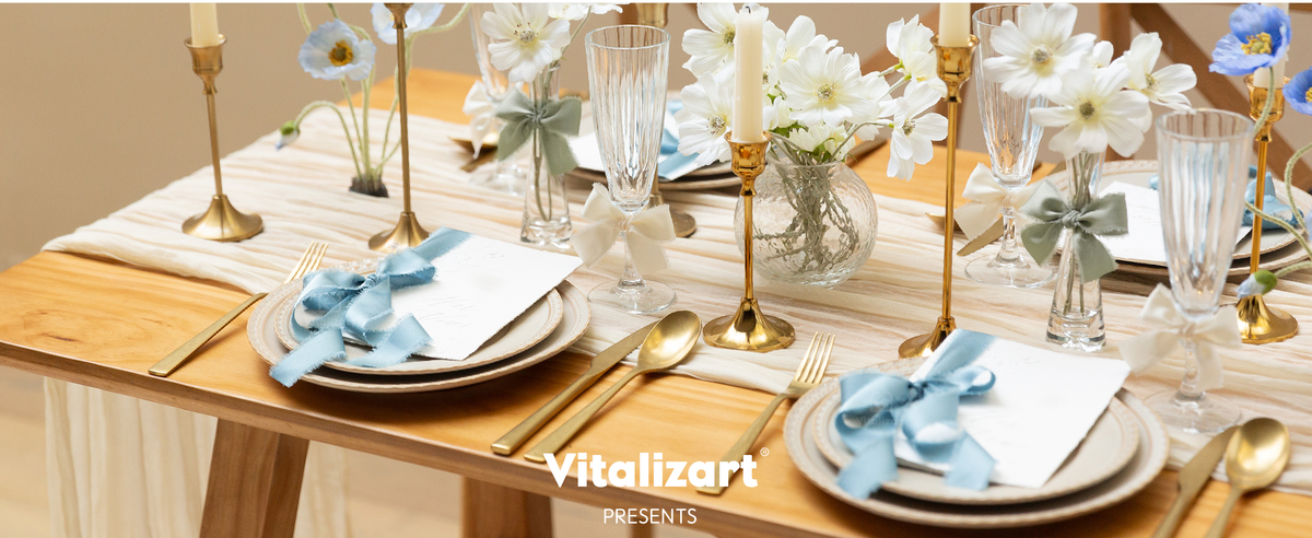 Blue, cream, and sage frayed ribbon decorates place cards, glasses, and flowers on a formal table.