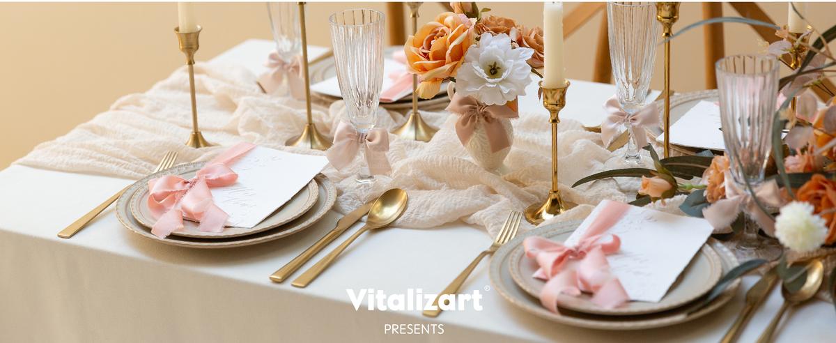 Pink and lavender frayed satin bows decorate glasses, place cards, and flowers on a formal table.