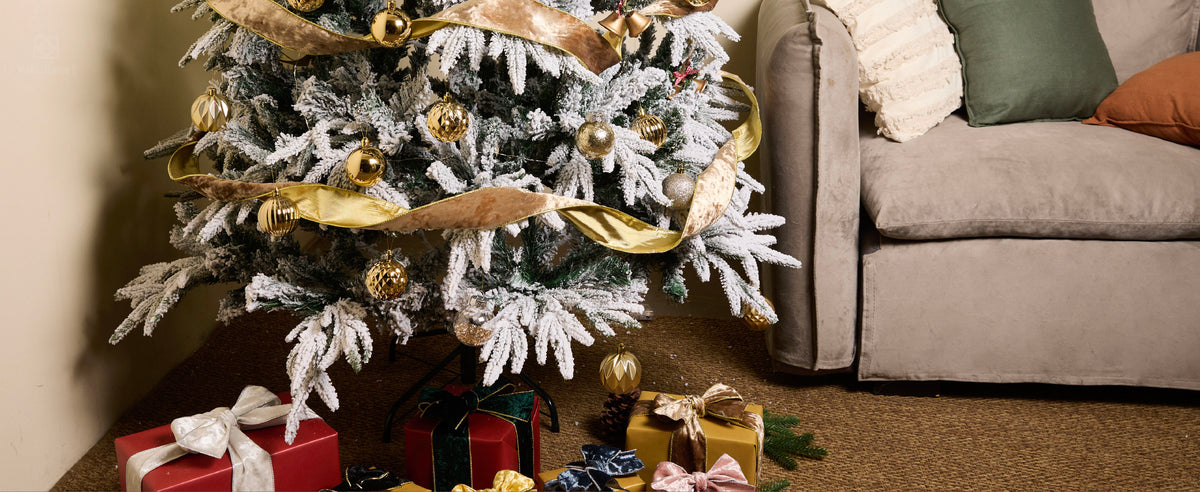Nude champagne velvet ribbon with gold metallic reverse spiraling around a flocked Christmas tree