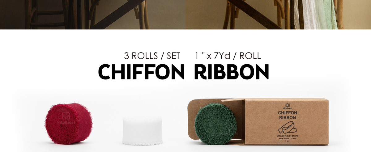 Three rolls of frayed chiffon ribbon in red, white and dark green beside a cardboard box