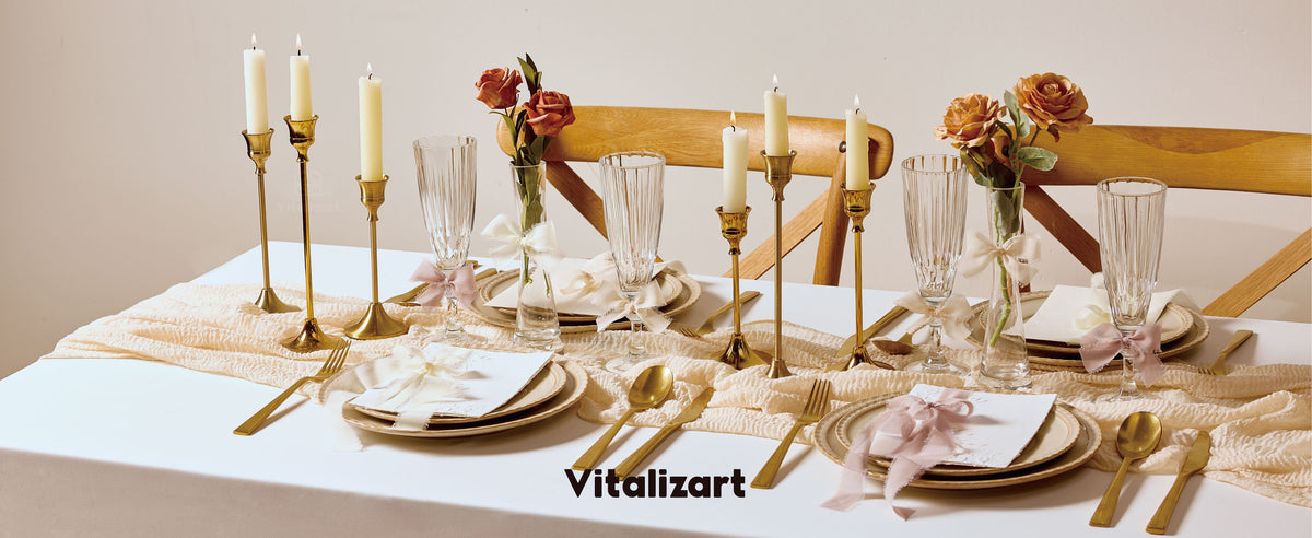 Blush and ivory chiffon ribbon bows accent a formal table set with roses, candles, glassware, and gold flatware.