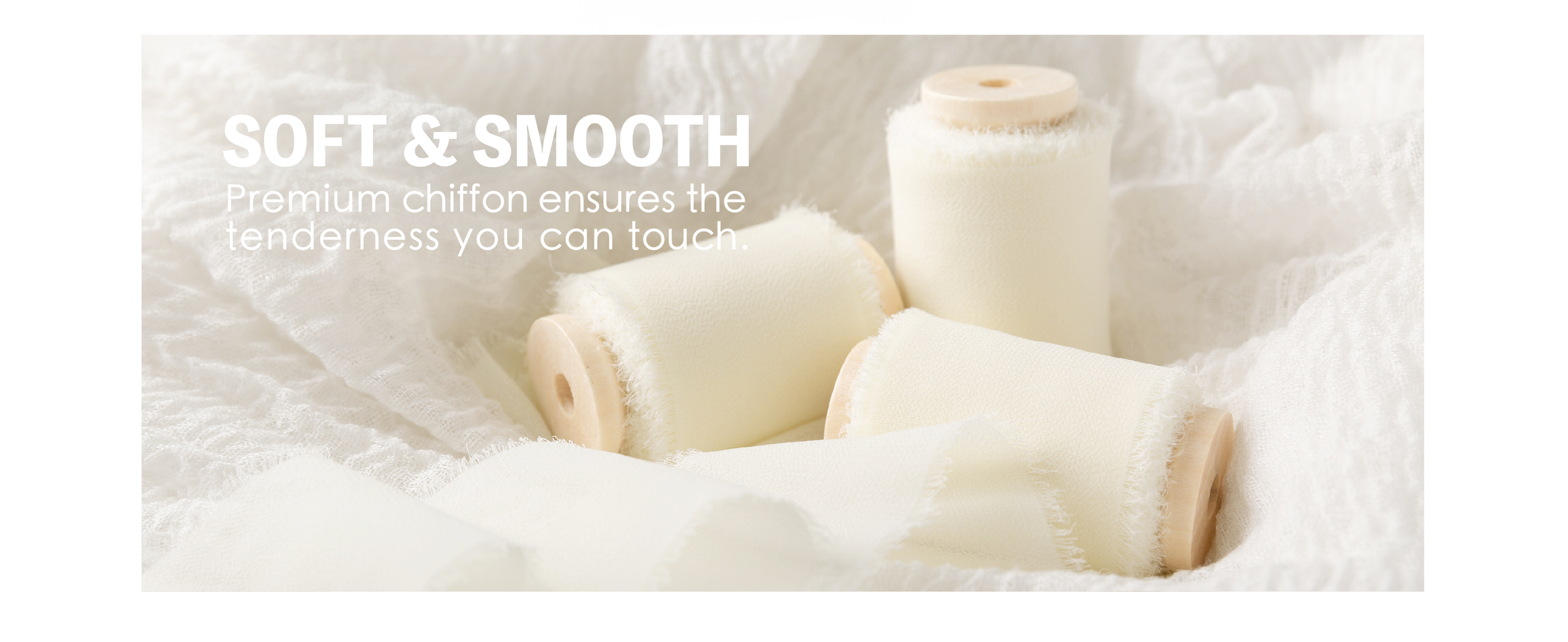 Three cream white chiffon ribbon rolls on wooden spools nestled in soft white fabric