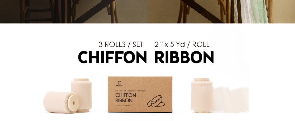 Three light nude chiffon ribbon rolls on wooden spools with kraft storage box