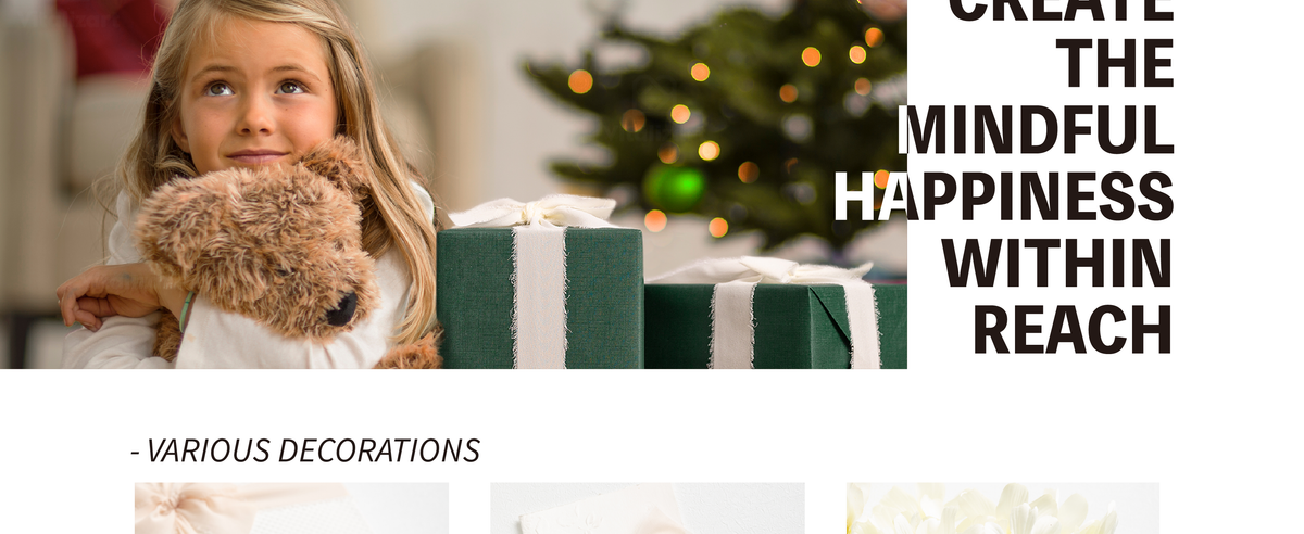Girl hugging a plush dog beside a green gift box wrapped with pale chiffon ribbon