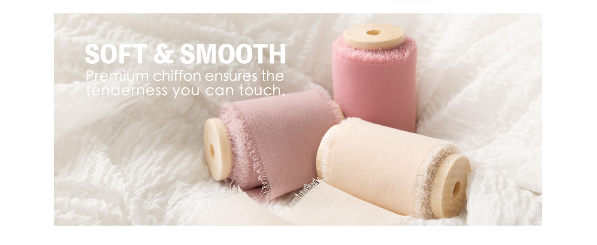 Pink, mauve, and nude chiffon ribbon rolls with frayed edges resting on soft white fabric.