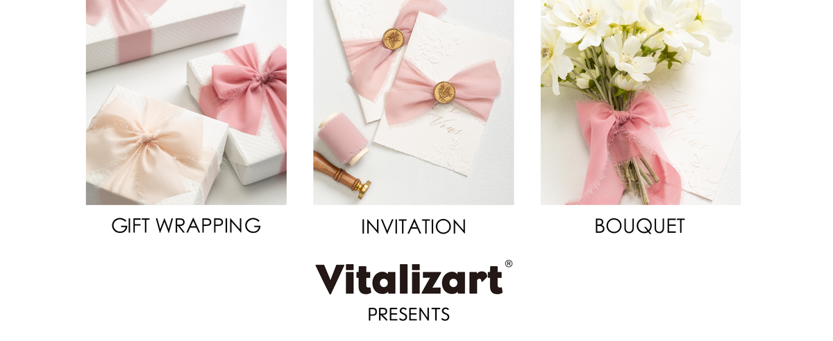 Pink and nude chiffon ribbon decorating gift boxes, wax-sealed invitations, and a white bouquet.