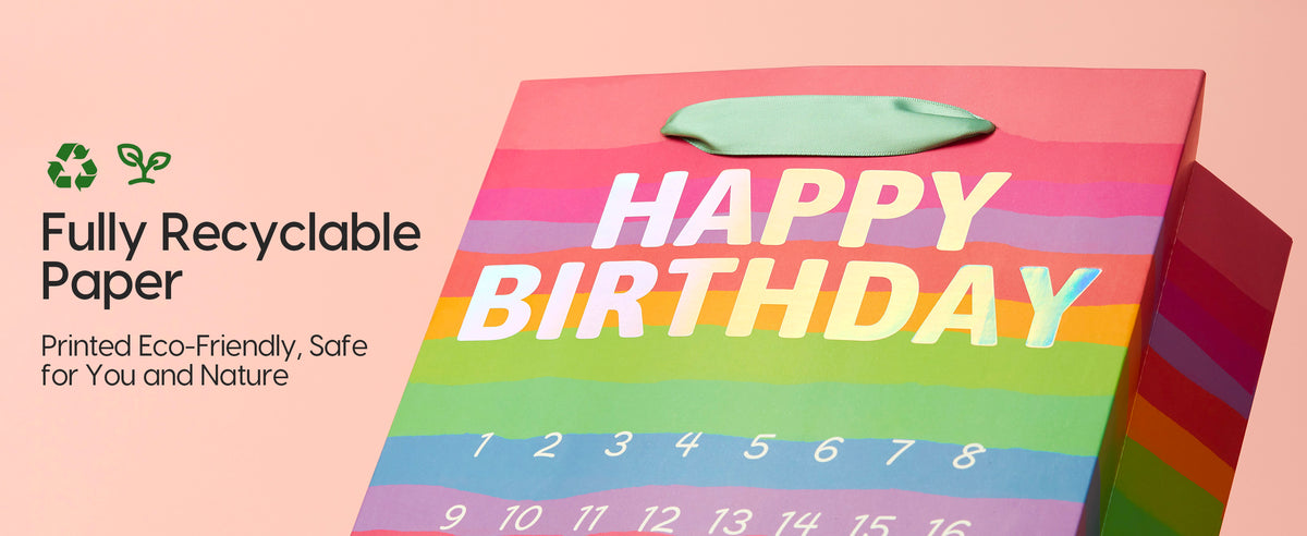 Rainbow-striped paper birthday gift bag with green base, mint ribbon handle, and numbered calendar