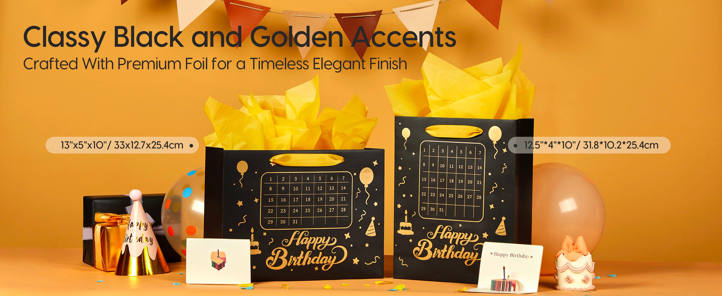 Two black paper birthday gift bags with gold designs, ribbon handles, yellow tissue, and calendars