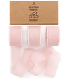Blush pink chiffon ribbon roll on a white background
