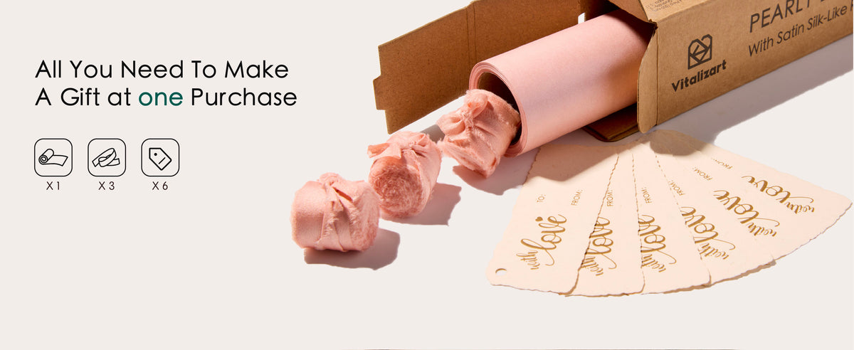 Pink wrapping paper set with one pearly roll, three ribbon bundles and six cream gift tags