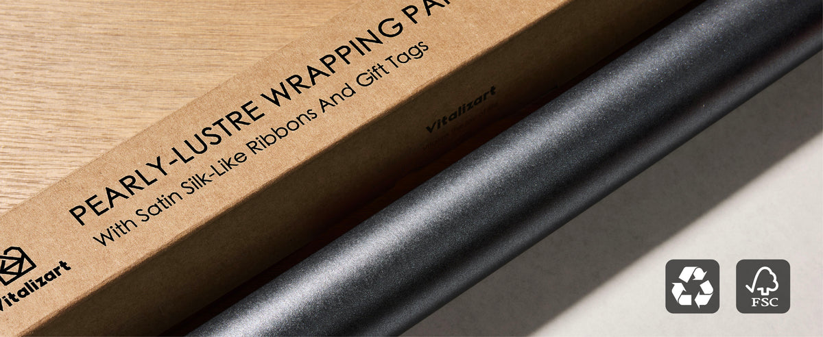 Pearly charcoal wrapping paper roll beside its kraft box with recycling and FSC symbols