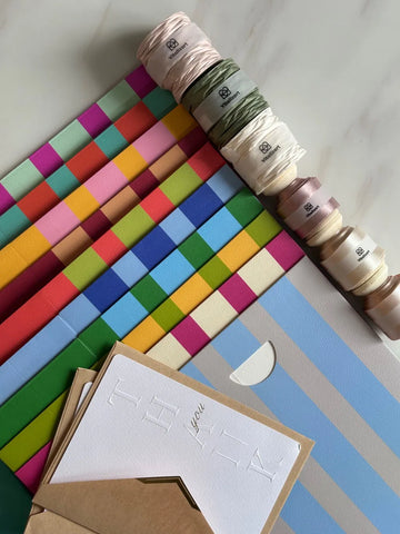 Colorful gift boxes, thank-you cards and Vitalizart ribbon spools