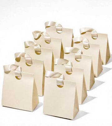 Set of small cream white paper gift bags with ribbon handles