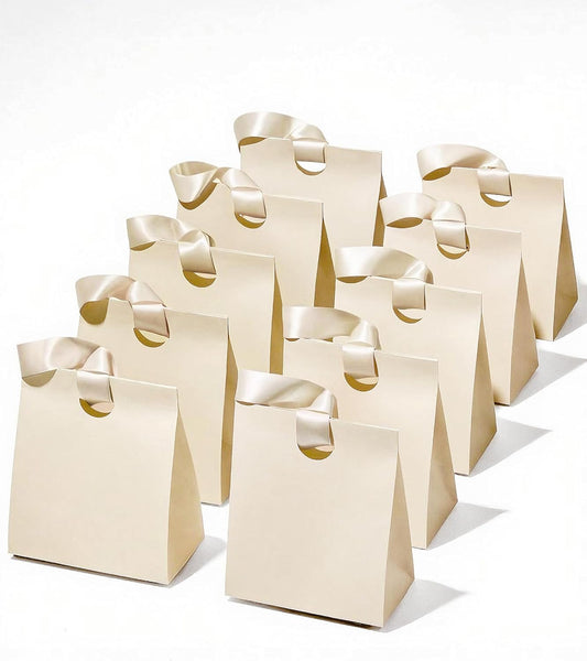 Set of small cream white paper gift bags with ribbon handles