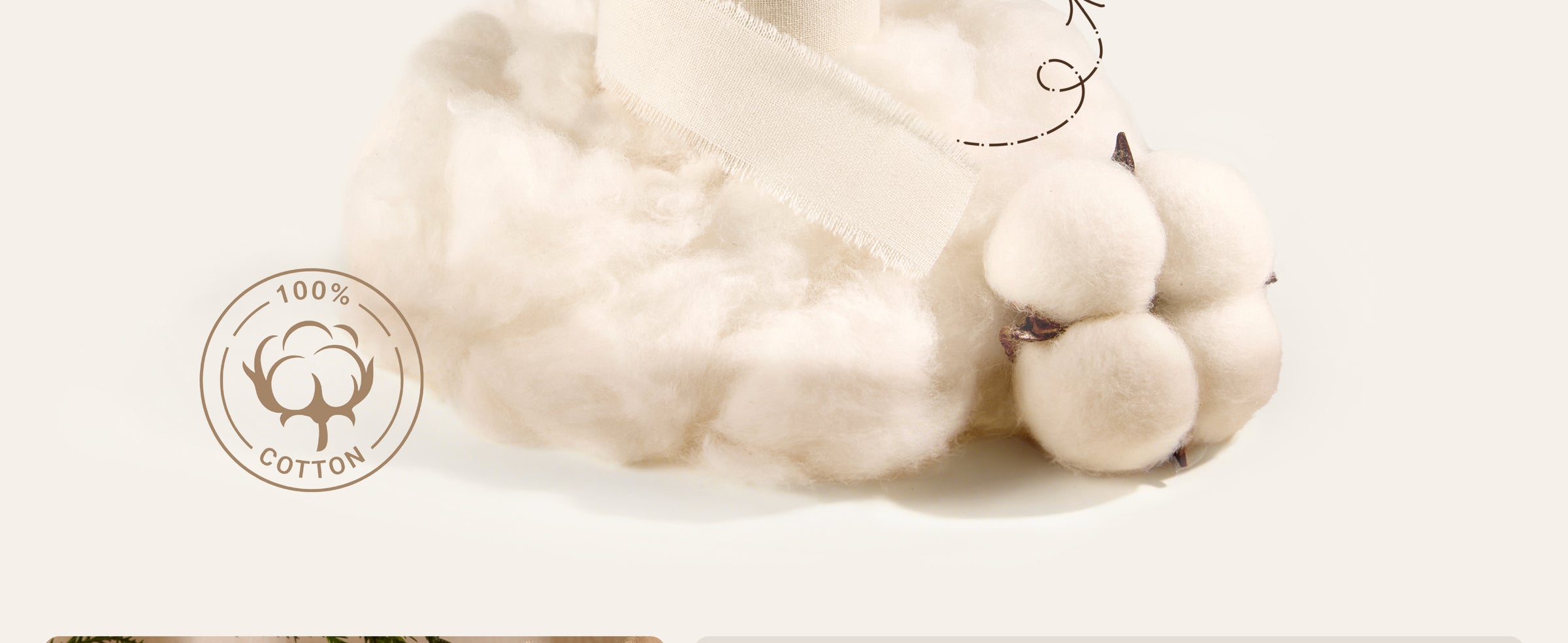 Ivory fringed cotton ribbon draped over raw cotton fiber and a natural cotton boll.